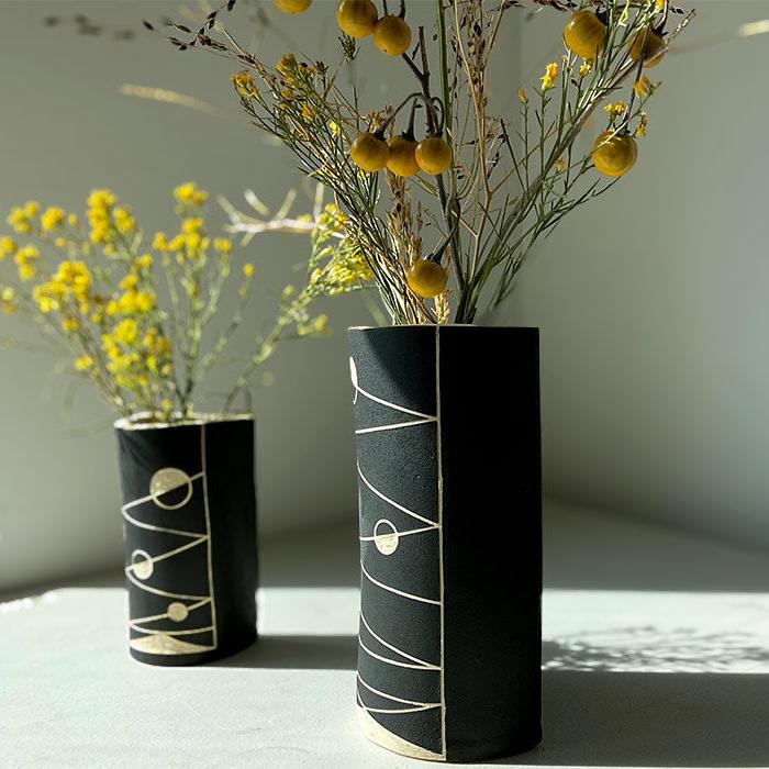 modern ceramic wall vases in black and white carved with an abstract linear design